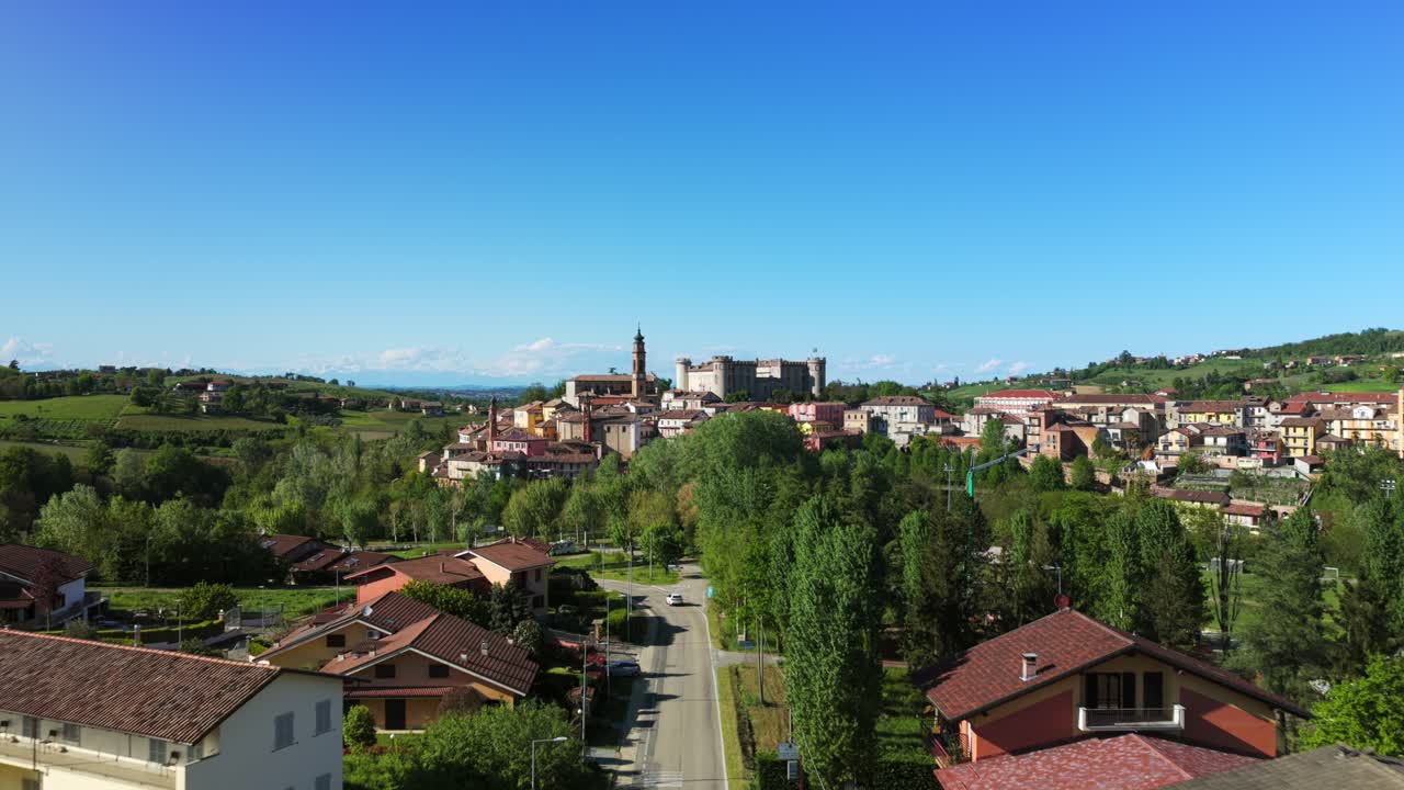 Costigliole d'Asti town, Piedmont, Italy. Aerial forward, clean blue sky for copy space