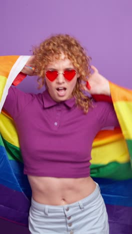 woman celebrating pride with a rainbow flag