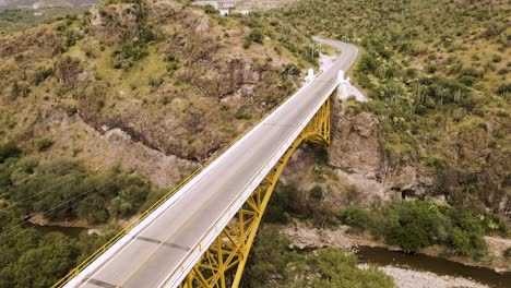 drone video of a bridge on the highway and below it passes a river in the middle of nature in the state of hidalgo in mexico