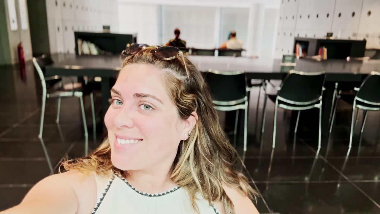 Smiling Vlogger Woman in a Modern Public Space