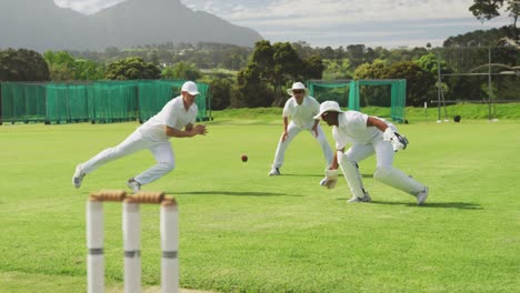 Cricket-player-catching-the-ball-on-the-pitch