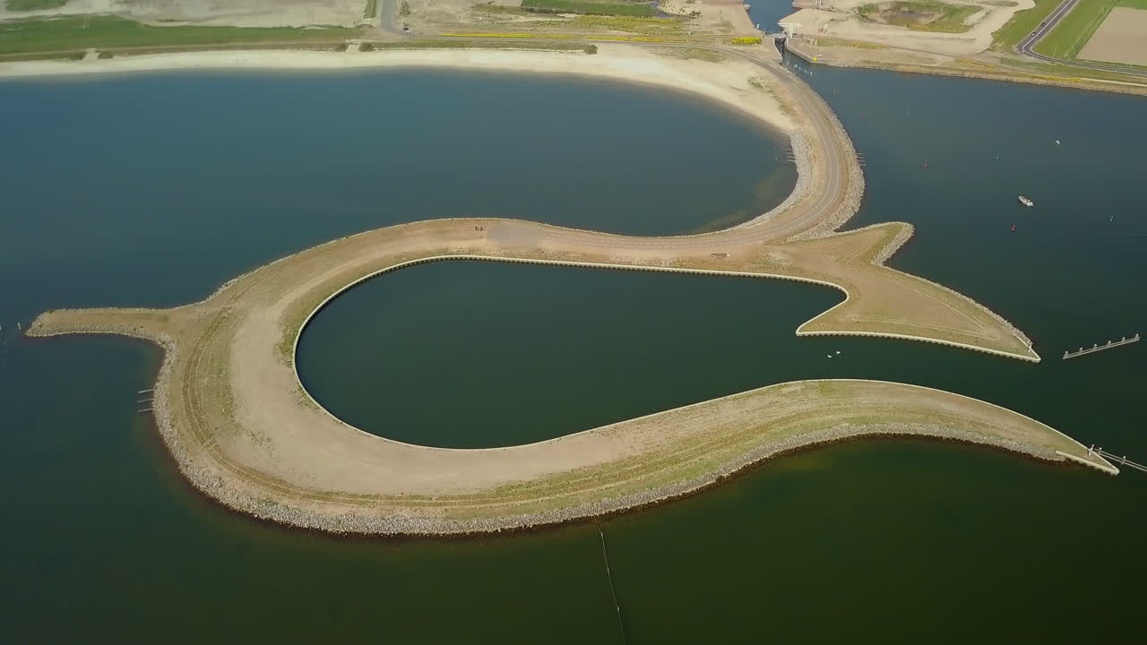 Aerial drone shot of tilting down over the manmade Tulip Island located at the coastline of the Zeewolde, Flevoland, the Netherlands.
