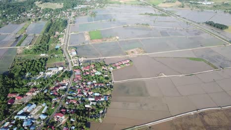 Aerial-overhead-shot-of-rural-Malays-kampung-village-near-paddy-field-at-Penang.