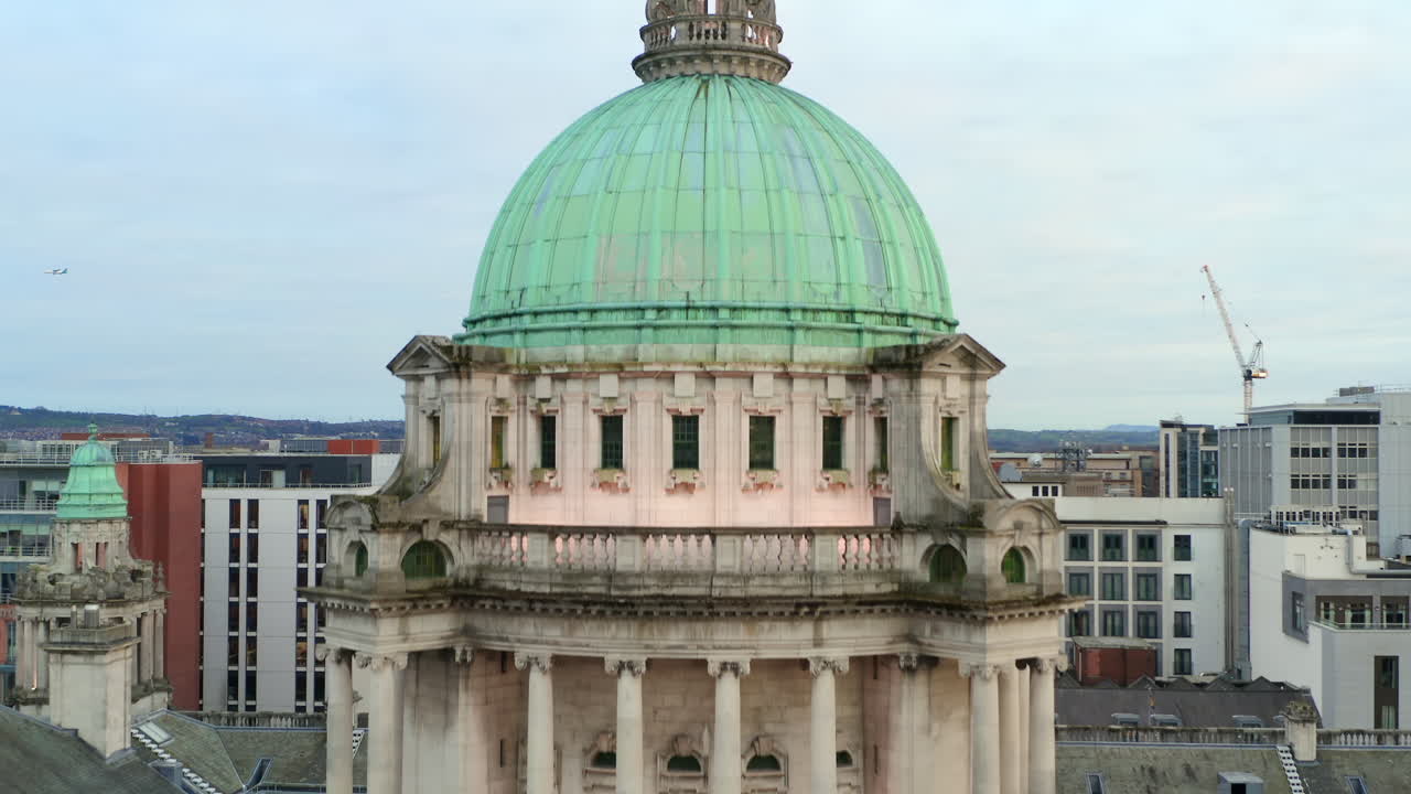 Descending drone footage from dome to detailed pediment sculptures on Belfast City Hall