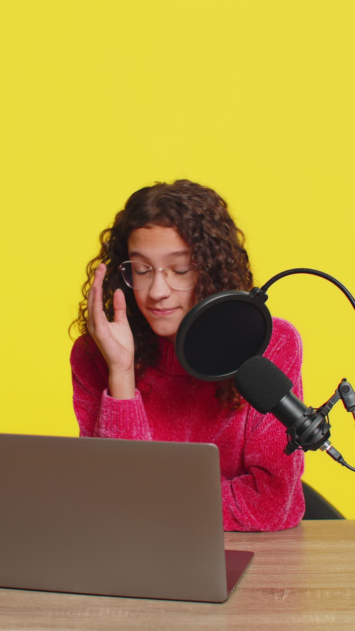 Girl blogger influencer recording podcast giving workshop webinar speaking in microphone and laptop