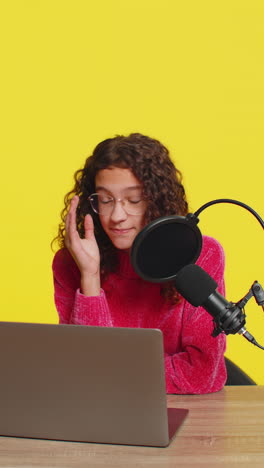 girl blogger influencer recording podcast giving workshop webinar speaking in microphone and laptop