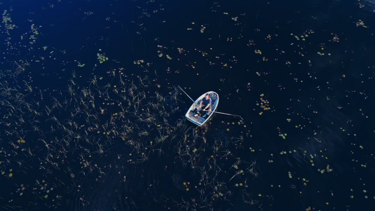 Aerial View Of A Wooden Dinghy Boat In A Calm Lake
