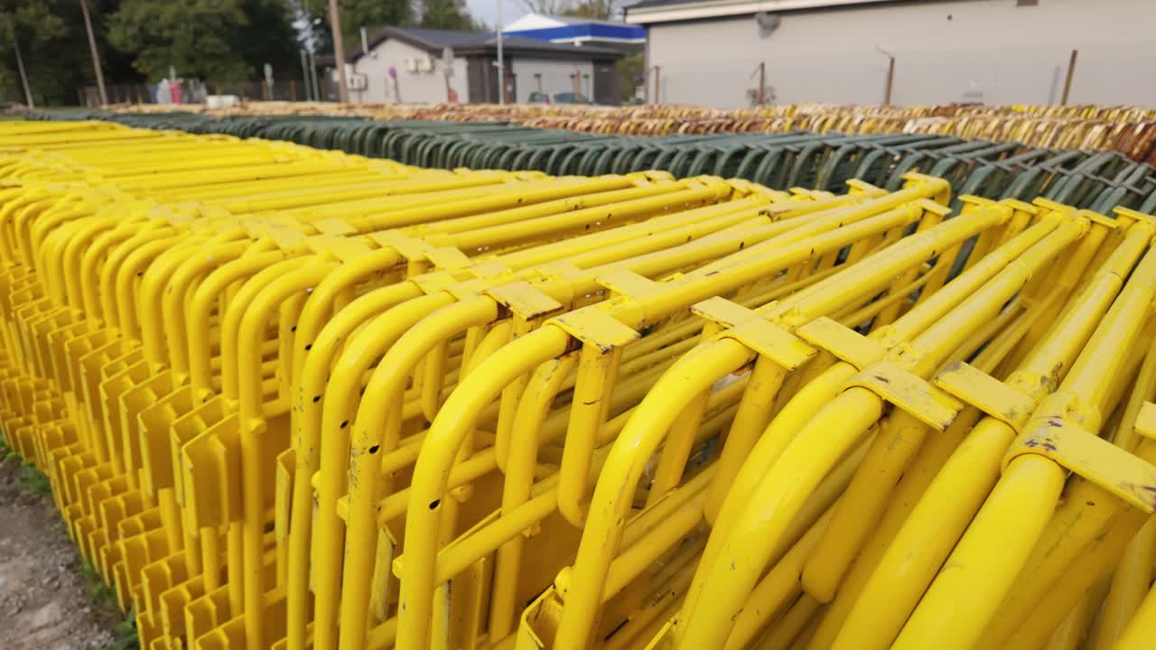 Camera glides beside protest barriers reflecting power structure and control