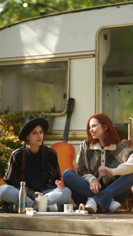 two women relaxing in autumn at a camper