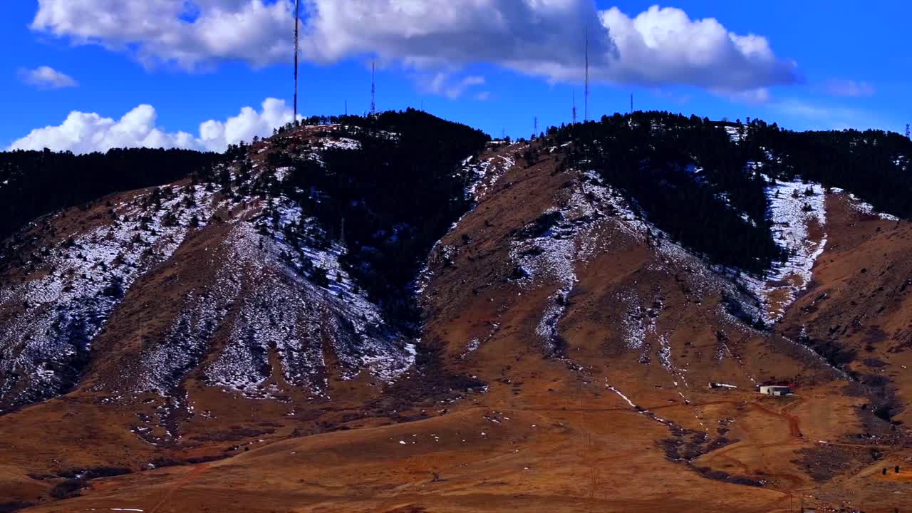 Lookout Mountain Genesse Evergreen Golden aerial drone Colorado snowy winter blue skies clouds Rocky Mountains Front Range power lines towers daytime sunny parallax circle right motion