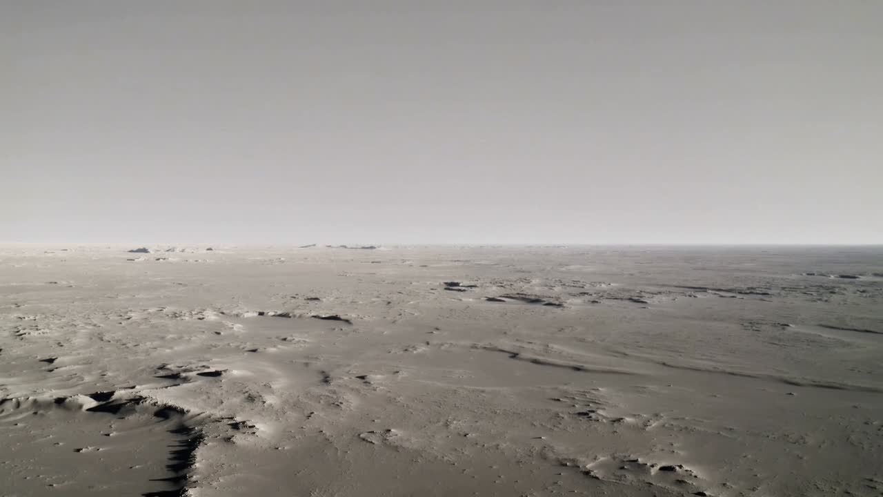 Panning camera recording barren plain with scattered rock outcrops and small ridges for surveying