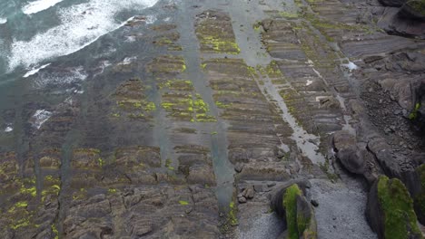 aerial view of the ocean waves dotted with rocks,