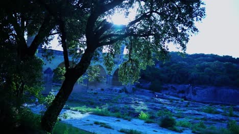 big bridge in the evening with sun shimmering through the trees in france