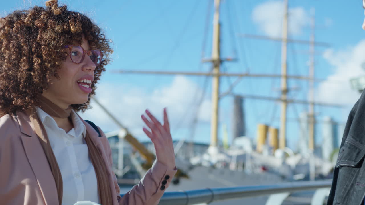 Young Black Businesswoman Talking with Female Friend Outdoors in the City