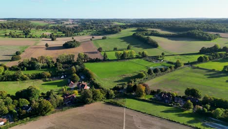 a view of british countryside with a footpath and lush green trees and fields