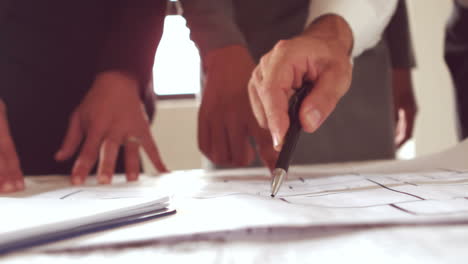 equipo de arquitectos mirando el plan de construcción