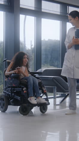 patient in wheelchair interacting with doctor