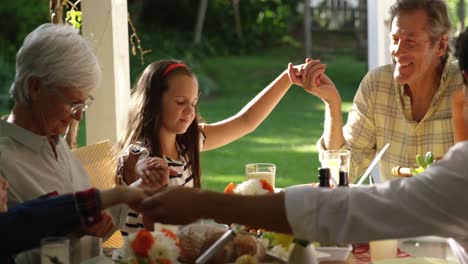 Family-eating-outside-together-in-summer