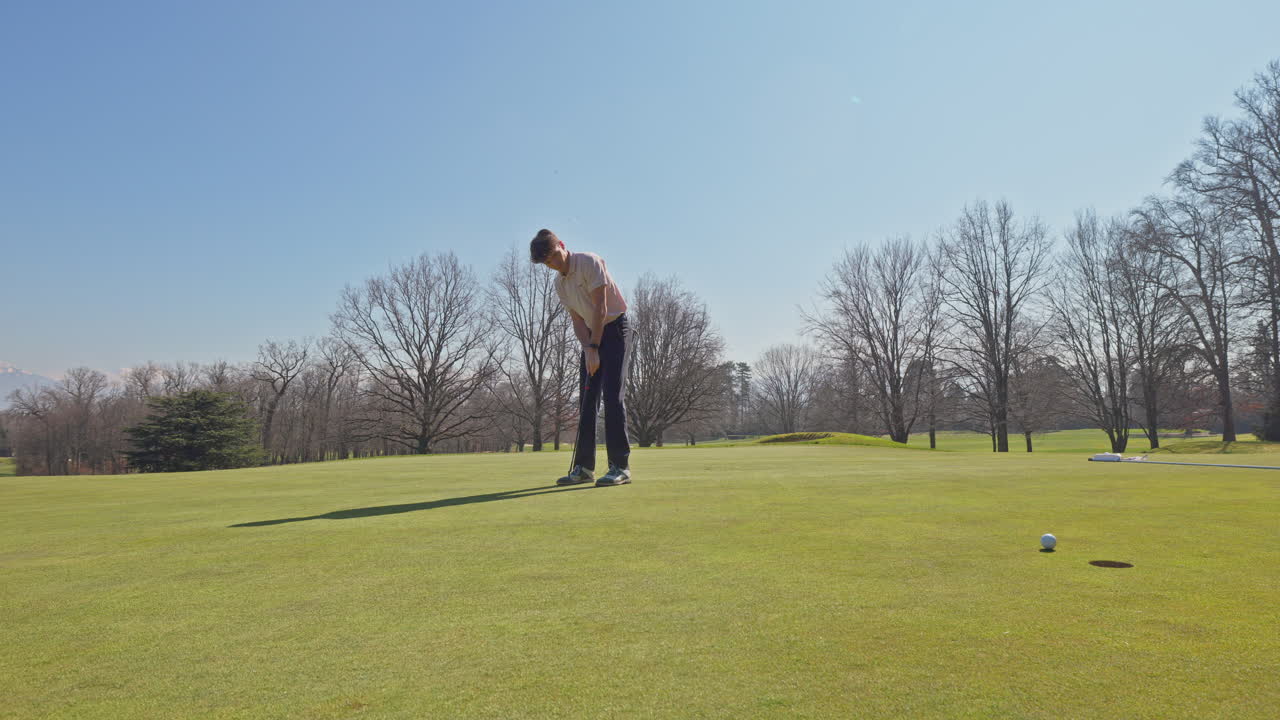 Young golfer playing on a sunny spring day in Switzerland, showcasing precise chipping, putting, bunker, and approach shots. Perfect for sports, lifestyle, and outdoor themes.