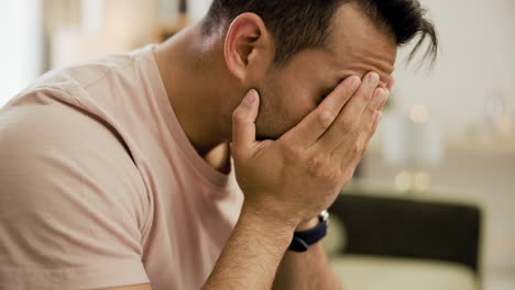 man covering face in distress