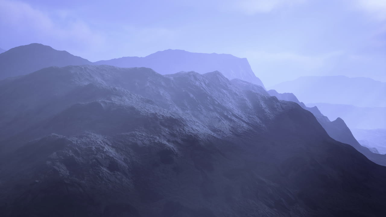 Misty mountain range creates serene atmosphere at dawn in the wilderness