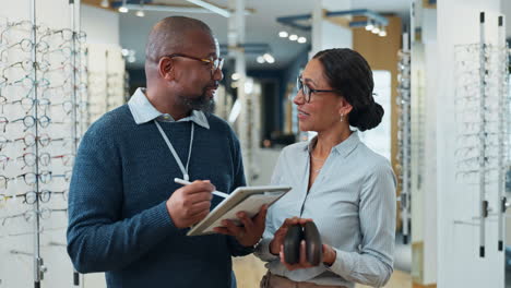 optician helping a customer choose new glasses