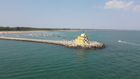 Rotating-drone-shot-of-Punta-Sabbioni's-lighthouse-on-a-sunny-day-in-Italy