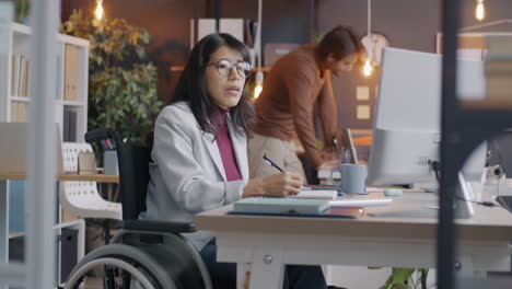 woman in a wheelchair working in an office