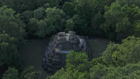 famous temple ruins at yaxha guatemala filmed from above, aerial