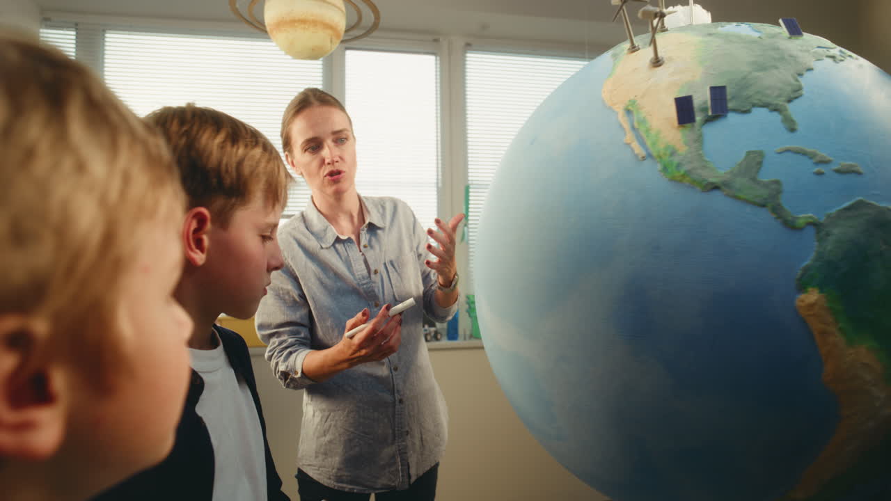 Elementary School Students Raising Hands to Provide Correct Answer During Geography Lesson