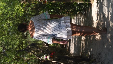 Woman-tourist-walking-down-jungle-path-towards-faré-hut-for-lunch,-New-Caledonia