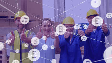 Animation-of-network-of-icons-over-diverse-supervisors-and-workers-showing-thumbs-up-at-warehouse