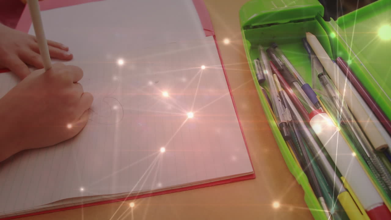 red brillante de conexiones contra la sección media de la chica caucásica dibujando en su libro en la escuela