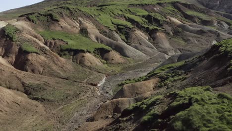 Aerial-flying-through-arid-valley-in-remote-Iceland-landscape-of-Sogin-Badlands