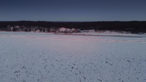 experience an aerial drone view of ice-covered lake erie, showcasing the frozen waters and the expansive winter landscape in striking detail.