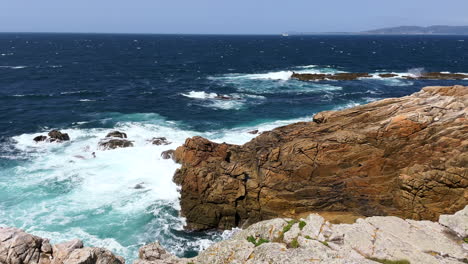 atlantic ocean waves crashing on the rocky coastline on a windy day