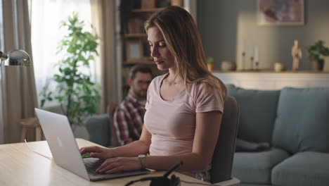 mujer trabajando en una computadora portátil en casa