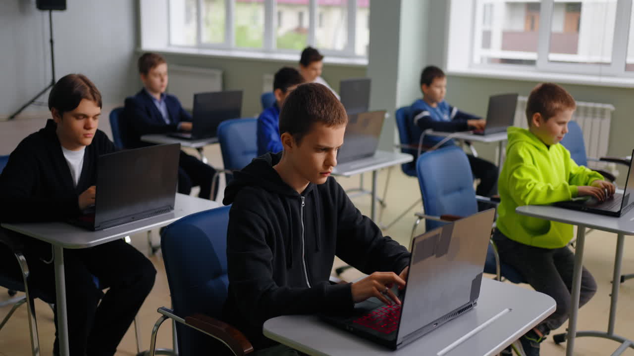 Students working on laptops in a classroom