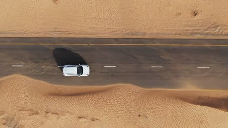 white car on desert road - aerial view