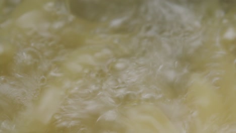 penne pasta being cooked in pot of boiling water
