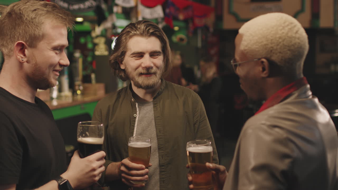 Men With Beers Talking At Pub