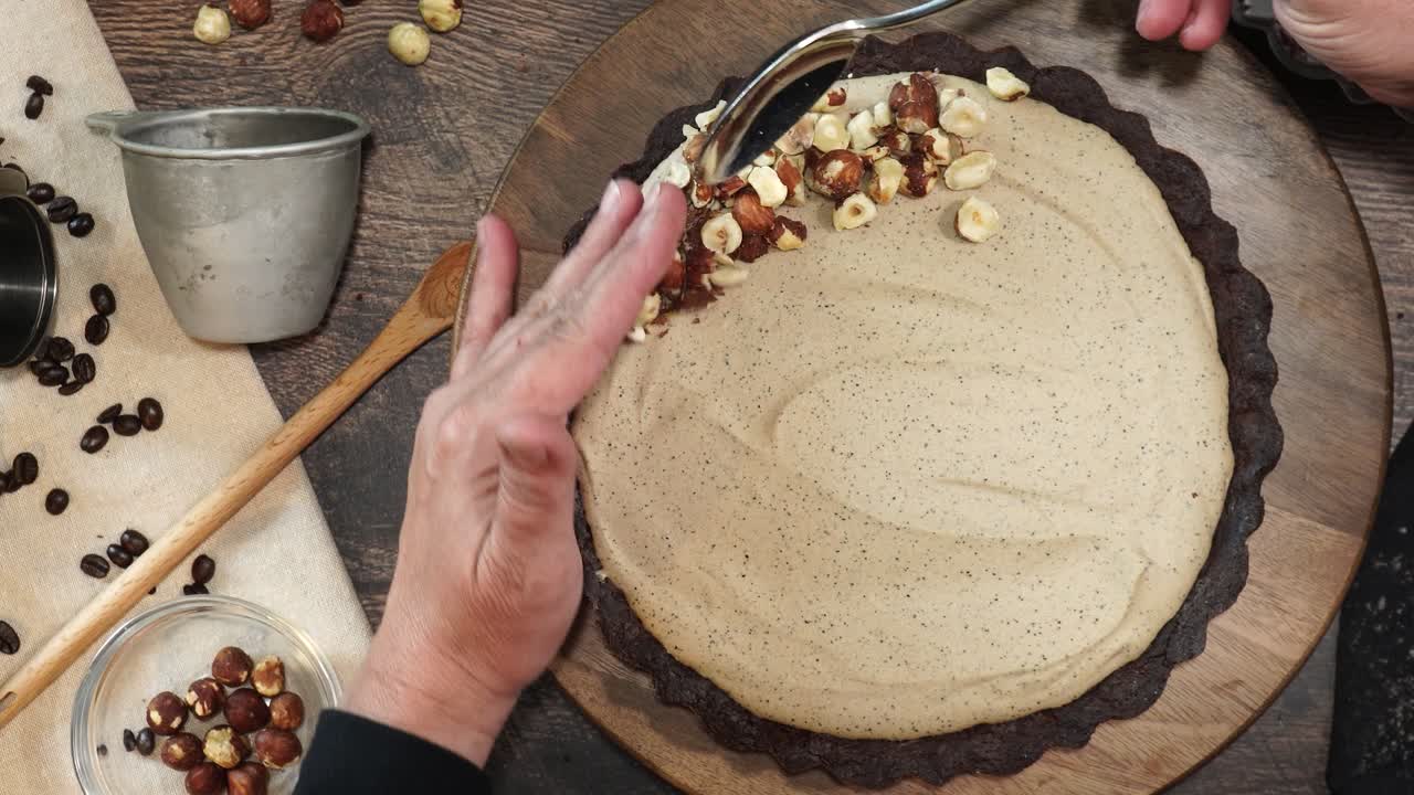 A delicious dessert, Coffee Hazelnut Cream Tart. Made with espresso powder, chocolate crust and loaded with crushed hazelnut. Adding hazelnuts to the top of the pie or tart as a garnish on a table