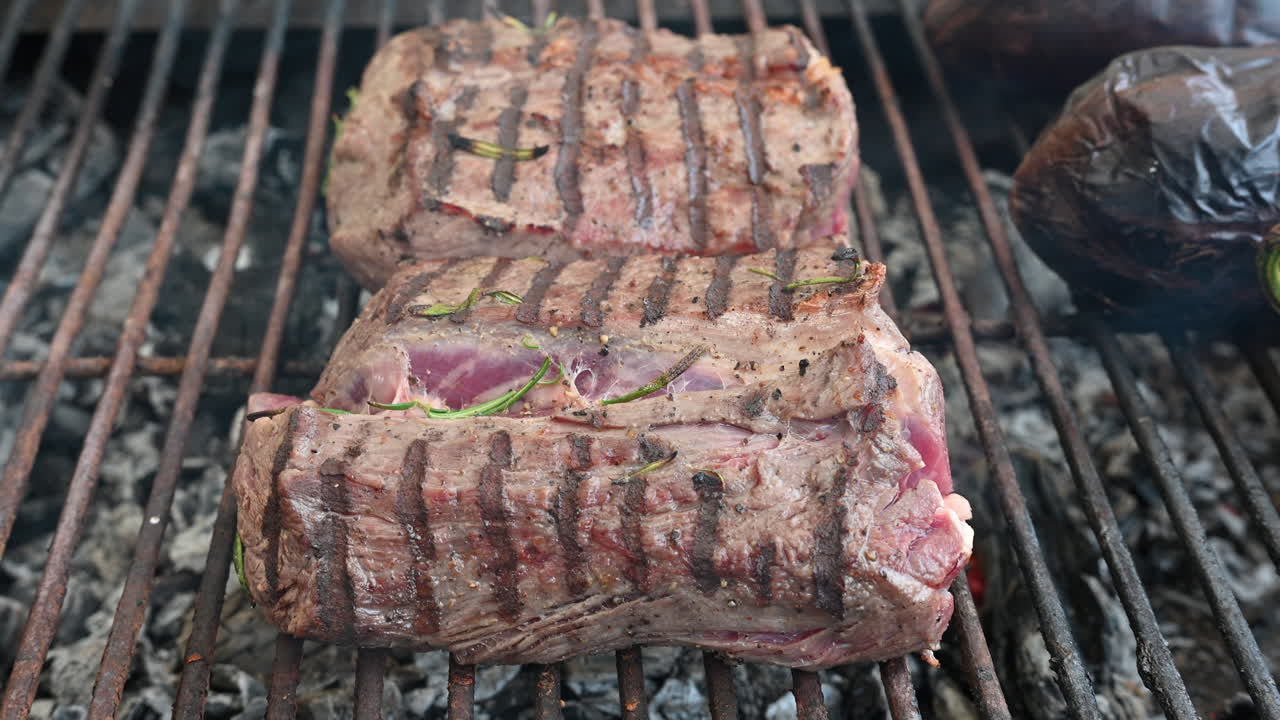 Pieces of beef being prepared on a grill