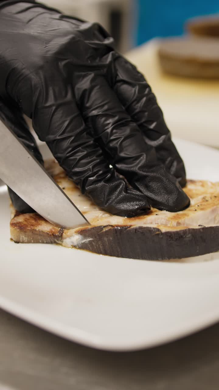 Chef Cleaning The Grilled Swordfish With The Knife During The Dish Preparation