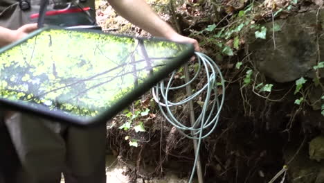 environmental scientists measure flow data from a river in switzerland