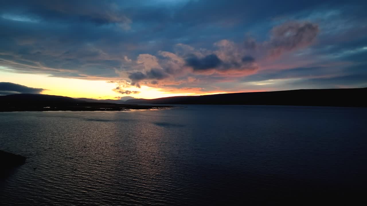 Sunset over Lagarfljót river near Egilsstaðir, Iceland - pullback aerial flyover