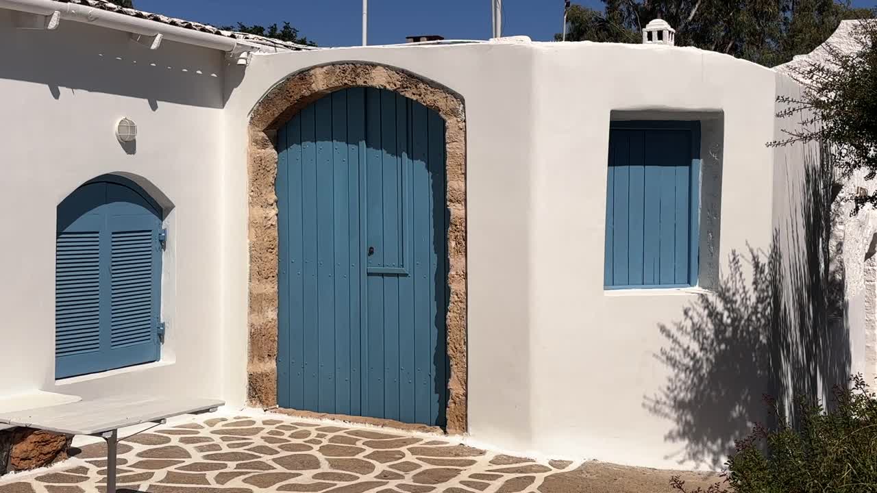 Picturesque coastal house with blue doors and windows, Crete, Greece