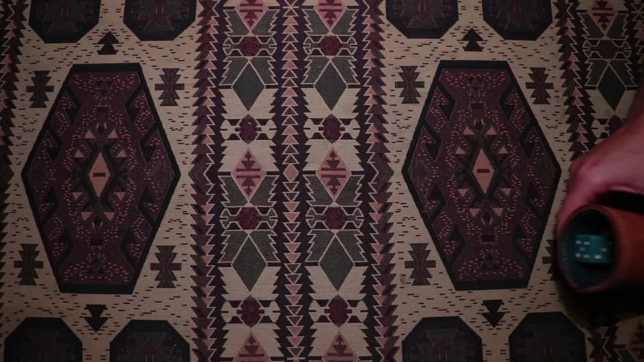 Guy rolling colored dices with a dice cup.