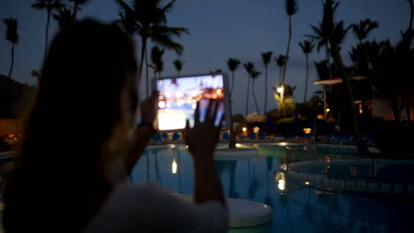 Woman-using-pad-to-take-photos-on-tropical-resort