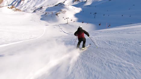 high speed skiing on a steep ski slope, male ski athlete with great skiing skills in beautiful mountain panorama in a austrian ski resort